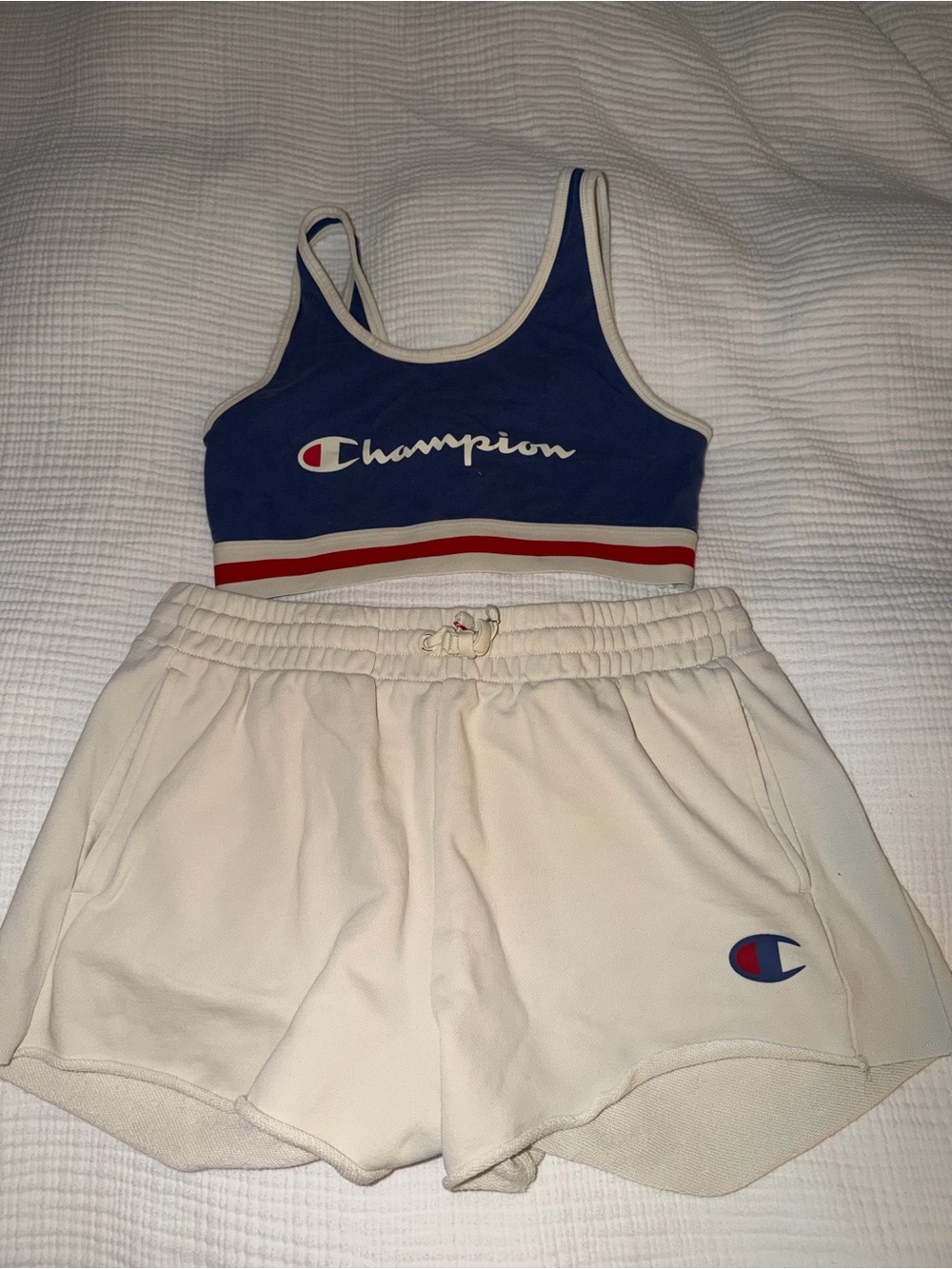 Champion Blue Sports Bra with Cream Shorts and Red Trim